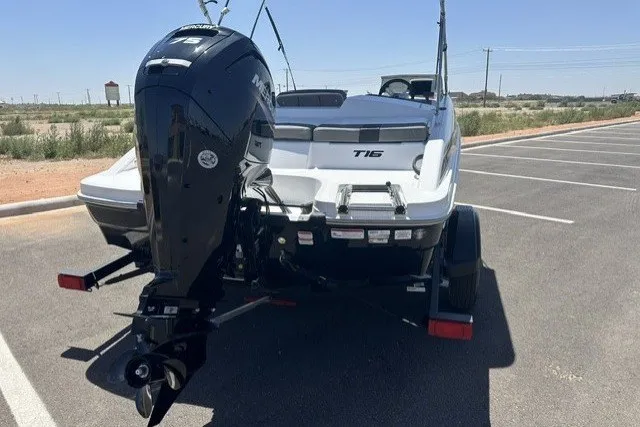 Slide: The Image of 2025 Tahoe T16 boat on trailer in sunny parking lot. - 7