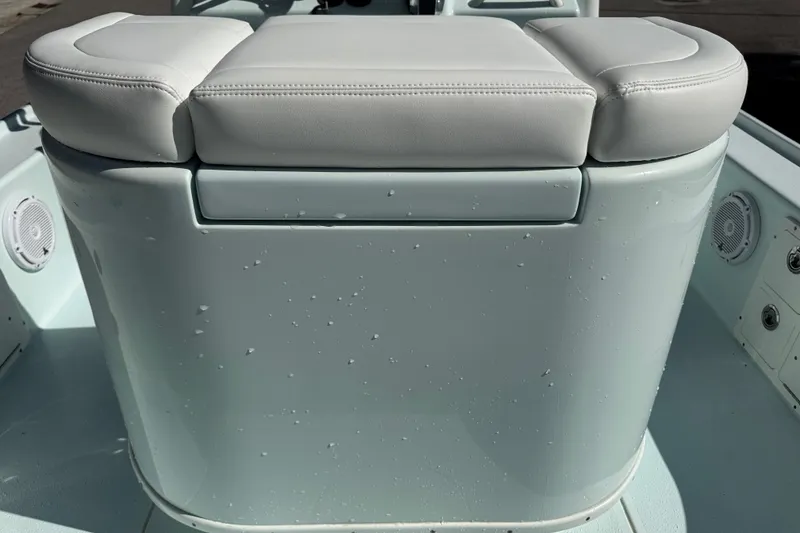 Slide: The Image of 2017 Yellowfin 24 Bay CE boat interior with cushioned seating and speakers. - 10