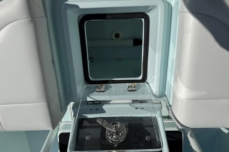 Slide: The Image of 2017 Yellowfin 24 Bay CE boat storage compartment with open hatch and seating. - 11