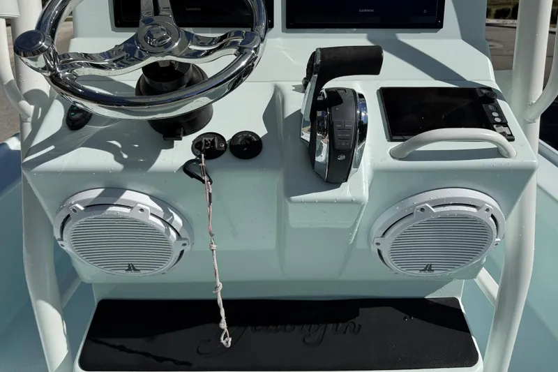 Slide: The Image of 2017 Yellowfin 24 Bay CE boat dashboard with steering wheel and controls. - 14