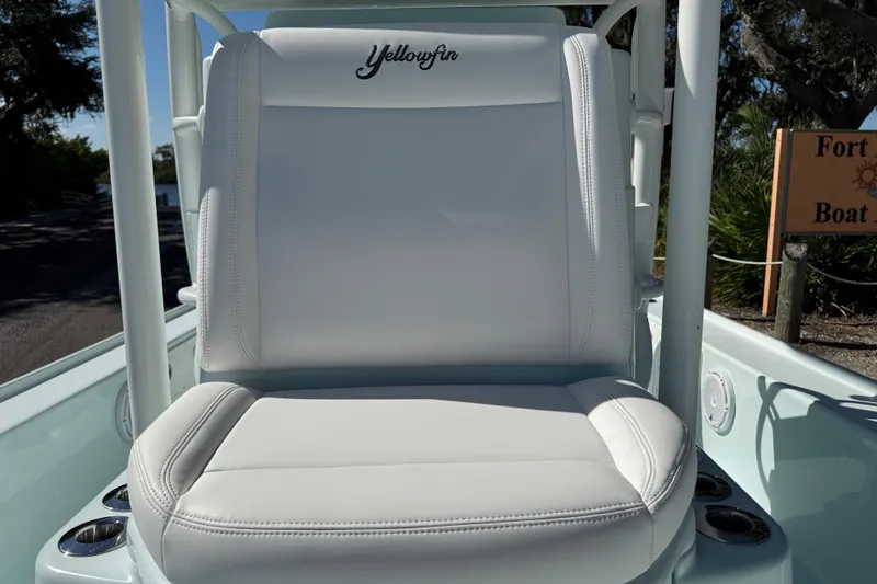 Slide: The Image of 2017 Yellowfin 24 Bay CE boat seat with logo, white upholstery, outdoor setting. - 22