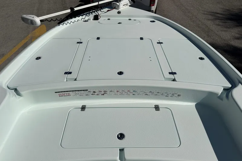 Slide: The Image of 2017 Yellowfin 24 Bay CE boat deck with storage compartments and trolling motor. - 28