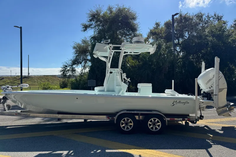Slide: The Image of 2017 Yellowfin 24 Bay CE boat on trailer, parked outdoors under clear sky. - 3
