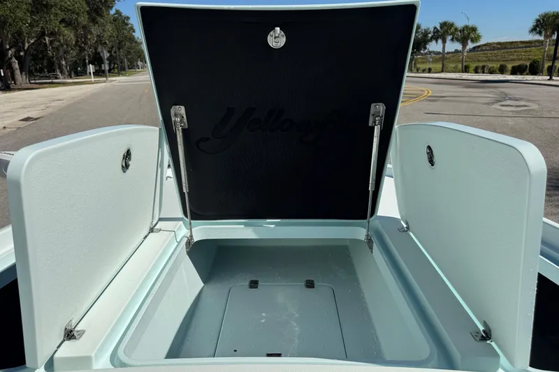 Slide: The Image of 2017 Yellowfin 24 Bay CE boat storage compartment open on a sunny day. - 35