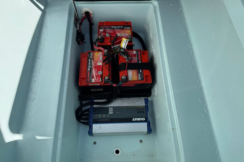 Slide: The Image of 2017 Yellowfin 24 Bay CE boat battery compartment with Odyssey Extreme batteries and Guest charger. - 37
