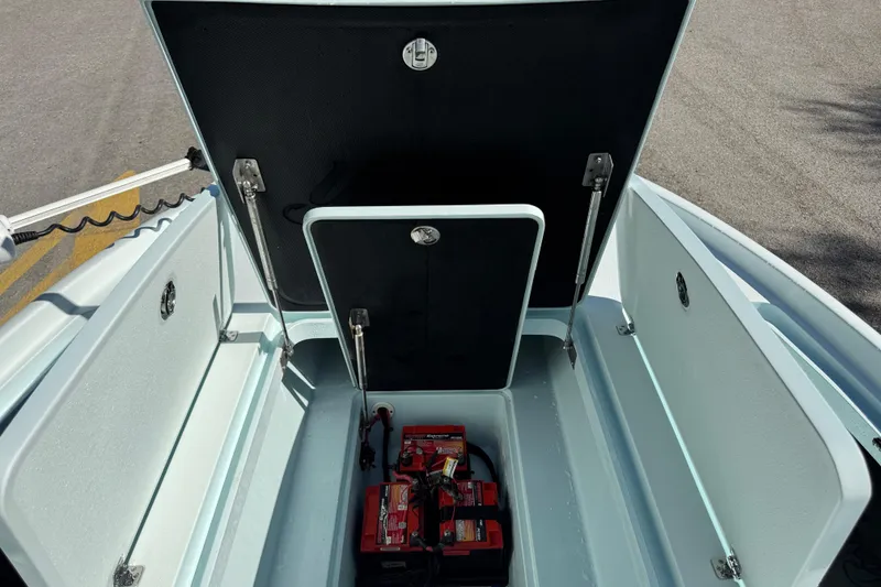 Slide: The Image of 2017 Yellowfin 24 Bay CE boat storage compartment with batteries visible. - 38