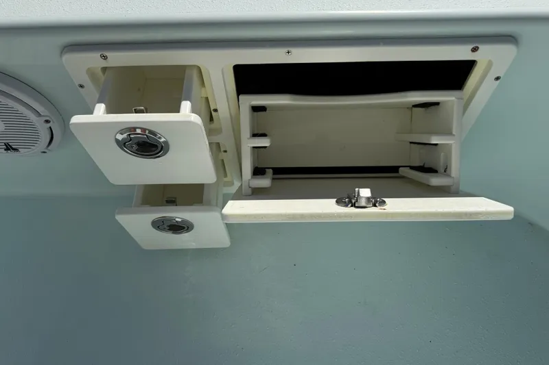 Slide: The Image of 2017 Yellowfin 24 Bay CE boat storage compartments and speaker detail. - 44