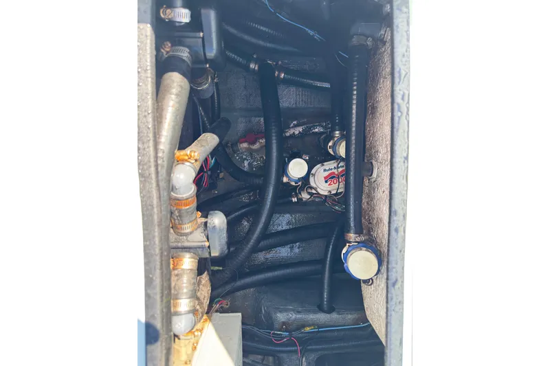 Slide: The Image of Engine compartment of 2017 Yellowfin 24 Bay CE boat with visible hoses and components. - 46