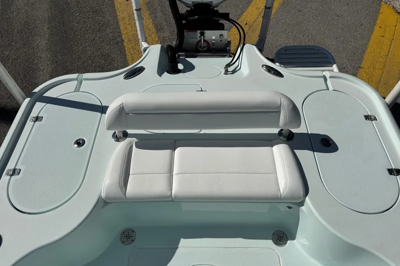 Slide: The Image of 2017 Yellowfin 24 Bay CE boat interior with white seating and storage compartments. - 5