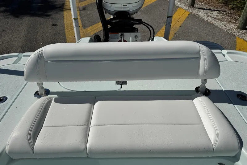 Slide: The Image of 2017 Yellowfin 24 Bay CE boat with white cushioned seating and motor in background. - 7