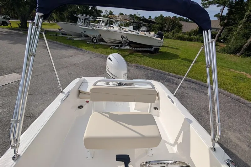 Slide: The Image of 2026 Robalo R160 Center Console boat interior with seating and outboard motor. - 8