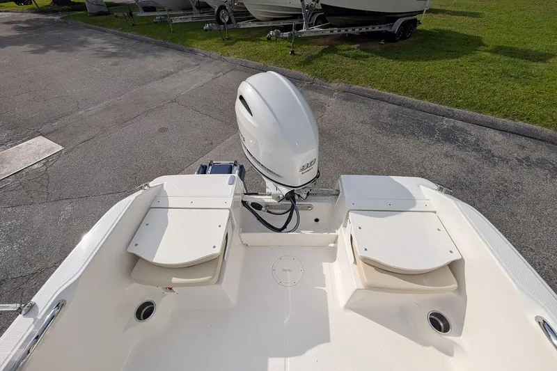 Slide: The Image of 2026 Robalo R160 Center Console boat with outboard motor, parked on pavement. - 9