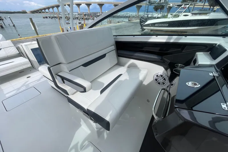 Slide: The Image of 2022 Blackfin 272 DC boat interior with sleek seating and modern dashboard. - 10