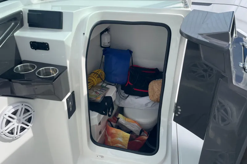 Slide: The Image of Interior storage of 2022 Blackfin 272 DC boat with various items and accessories. - 11