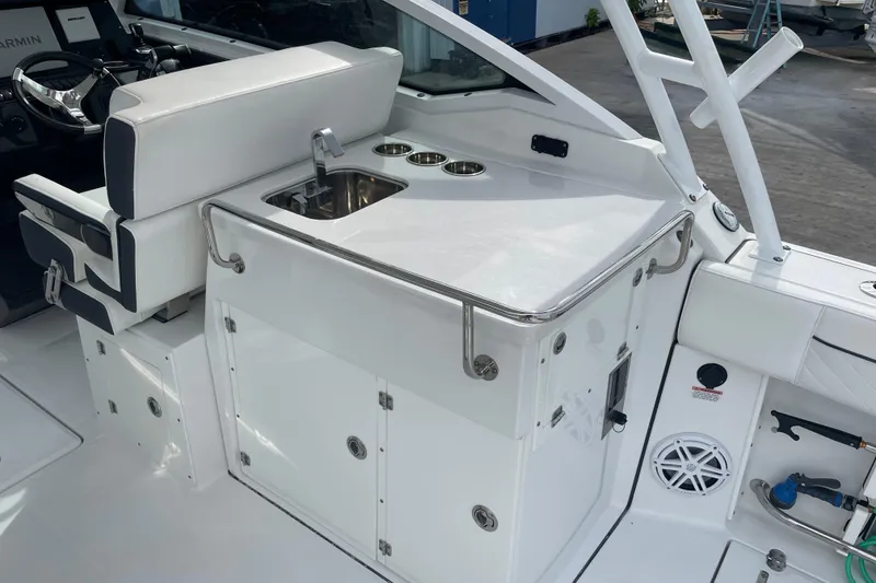 Slide: The Image of 2022 Blackfin 272 DC boat interior with sink and seating area. - 15