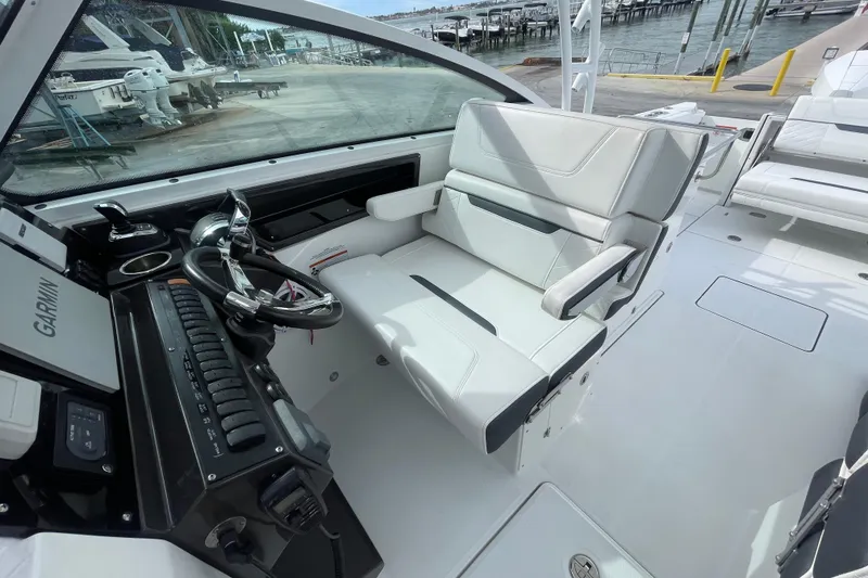 Slide: The Image of 2022 Blackfin 272 DC boat cockpit with steering wheel and seating. - 18