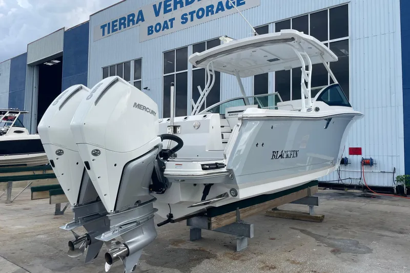 Slide: The Image of 2022 Blackfin 272 DC boat with dual Mercury engines at Tierra Verde Boat Storage. - 2
