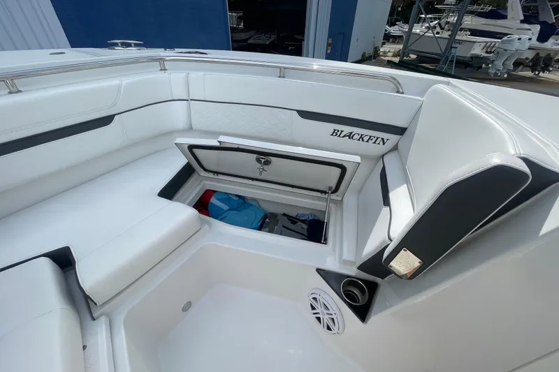 Slide: The Image of 2022 Blackfin 272 DC boat interior with open storage compartment and seating. - 20