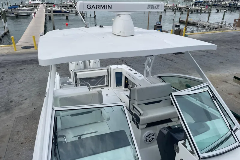Slide: The Image of 2022 Blackfin 272 DC boat docked, featuring Garmin xHD2 radar, spacious seating, and modern design. - 21