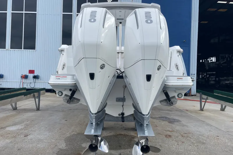 Slide: The Image of 2022 Blackfin 272 DC boat with twin outboard engines, docked at a marina. - 4