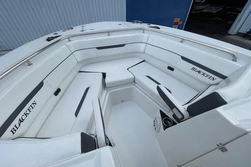 Slide: The Image of 2022 Blackfin 272 DC boat interior with white seating and stainless steel railings. - 7