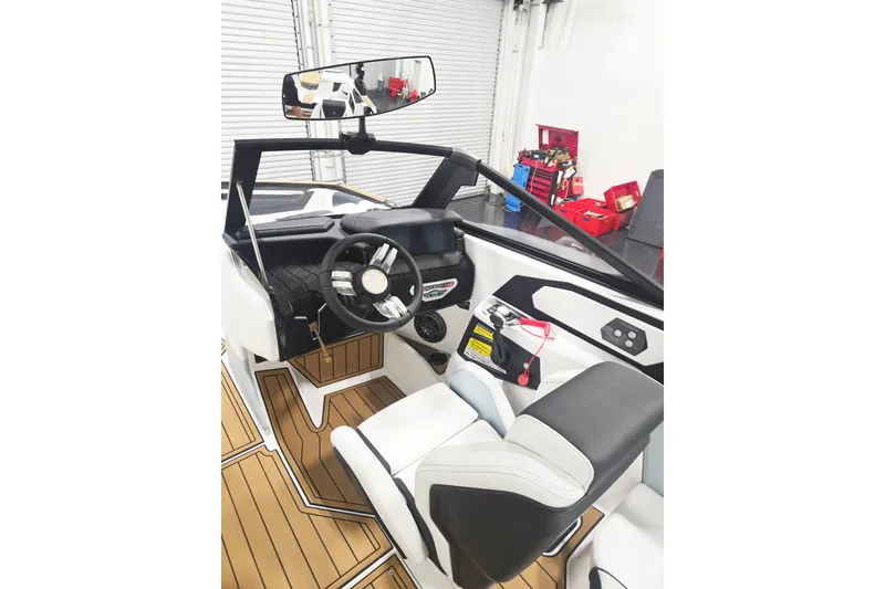 Slide: The Image of Interior of 2026 Nautique Super Air Nautique S21 boat, featuring modern steering and seating. - 6