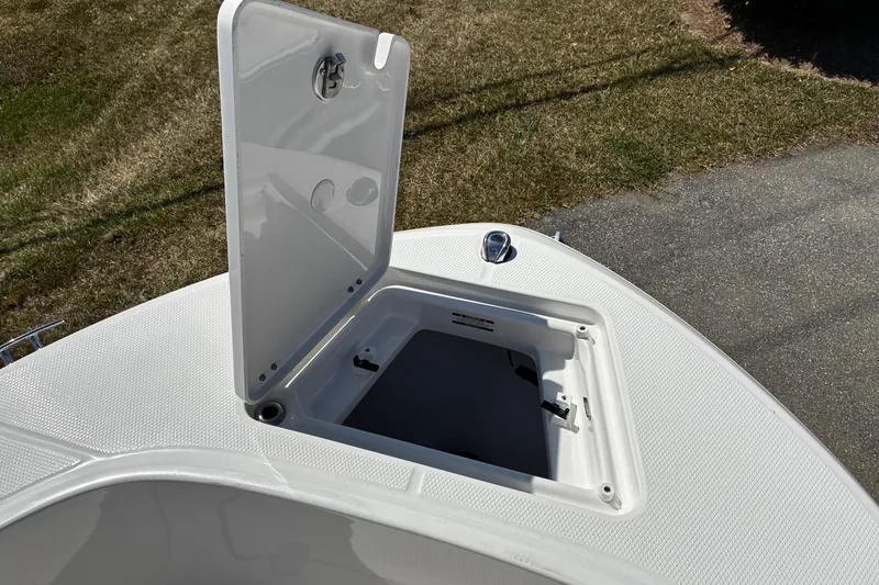 Slide: The Image of 2026 Robalo R180 Center Console boat with open storage compartment on deck. - 11