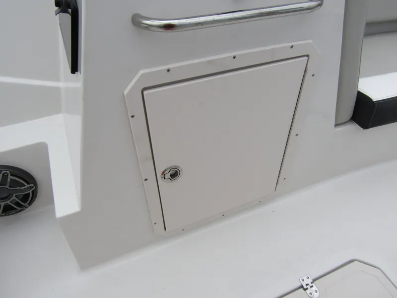 Slide: The Image of 2024 Starcraft SVX 231 OB DH boat storage compartment with secure latch and sleek design. - 17