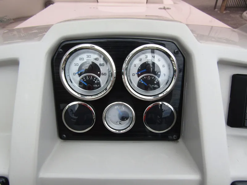 Slide: The Image of Dashboard of 2024 Starcraft SVX 231 OB DH boat with gauges and controls. - 24