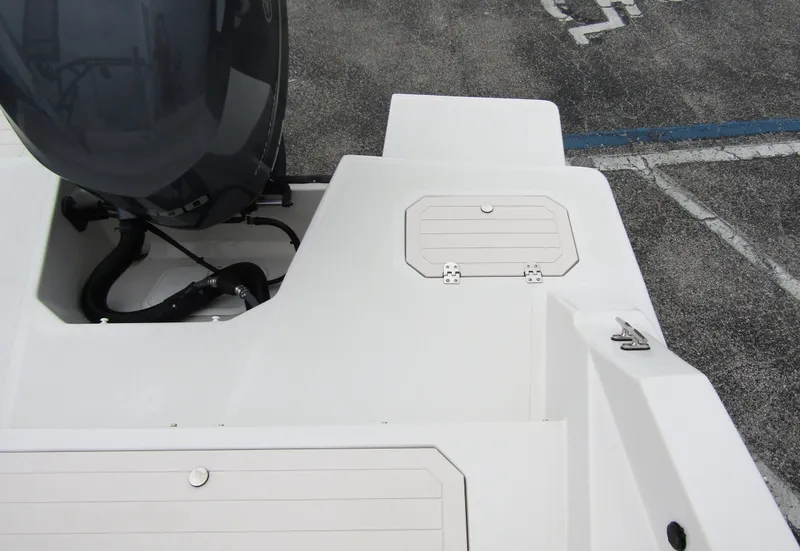 Slide: The Image of 2024 Starcraft SVX 231 OB DH boat stern with engine and storage compartments. - 31