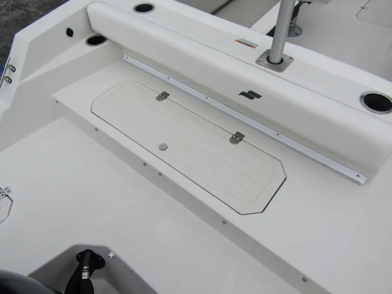 Slide: The Image of 2024 Starcraft SVX 231 OB DH boat interior with storage compartment and seating area. - 35