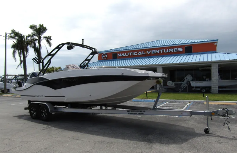 Slide: The Image of 2024 Starcraft SVX 231 OB DH boat on trailer at Nautical Ventures dealership. - 4