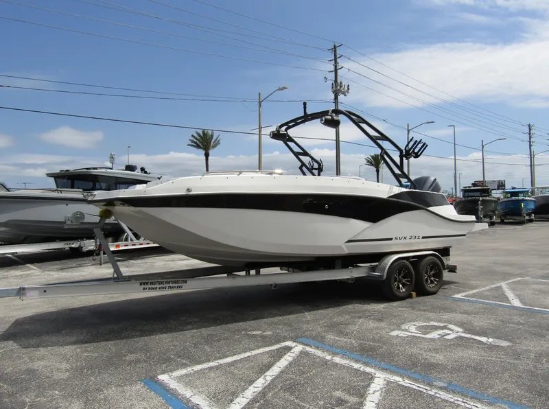Slide: The Image of 2024 Starcraft SVX 231 OB DH boat on trailer in parking lot. - 5