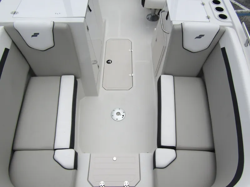 Slide: The Image of 2024 Starcraft SVX 231 OB DH boat interior with cushioned seating and storage compartments. - 8