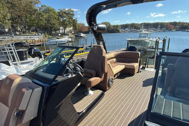 Slide: The Image of 2024 Premier Supersport boat with luxurious seating, docked by a scenic marina. - 10