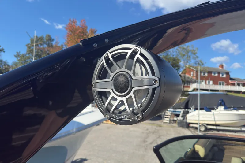 Slide: The Image of 2024 Premier Supersport boat with JL Audio speaker, docked under clear blue sky. - 11