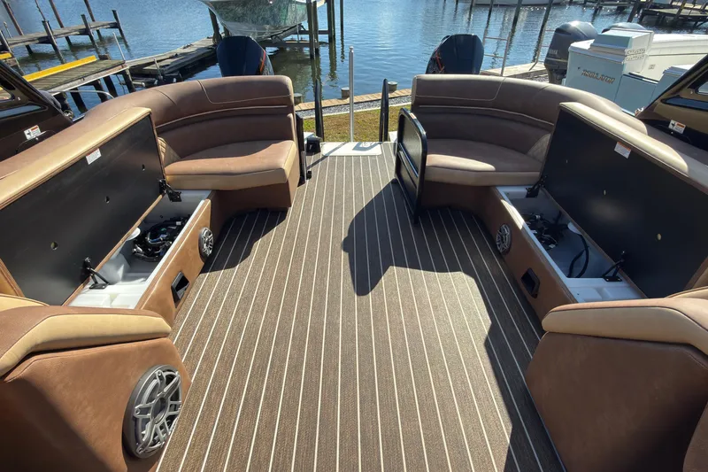 Slide: The Image of Luxurious 2024 Premier Supersport boat interior with open storage compartments and waterfront view. - 13