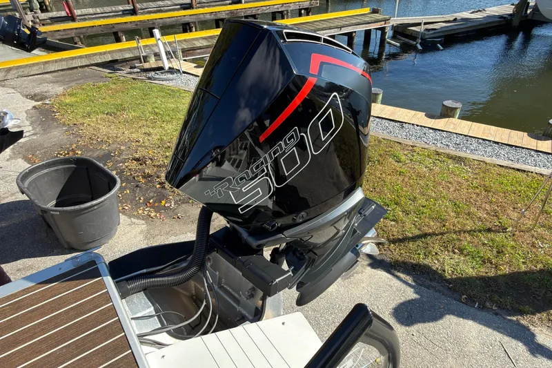 Slide: The Image of 2024 Premier Supersport boat engine by the water, featuring "Racing 300" branding. - 14