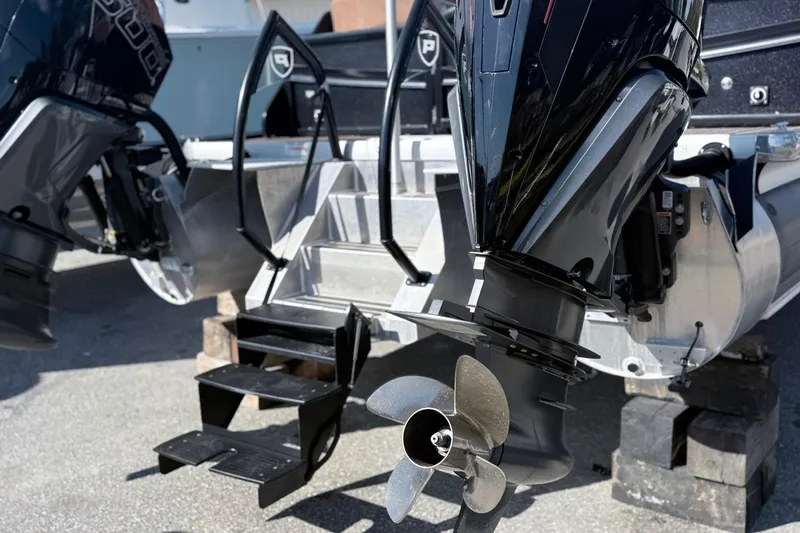 Slide: The Image of 2024 Premier Supersport boat with dual outboard motors and propellers, featuring a sturdy boarding ladder. - 16