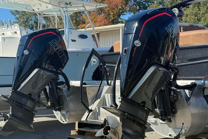 Slide: The Image of Twin outboard motors on a 2024 Premier Supersport boat, docked outdoors. - 2