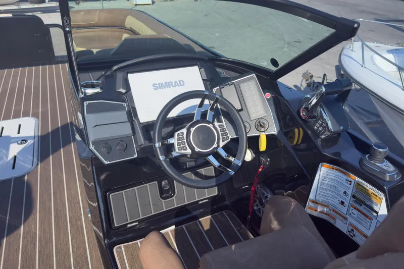 Slide: The Image of 2024 Premier Supersport boat dashboard with steering wheel and navigation system. - 5