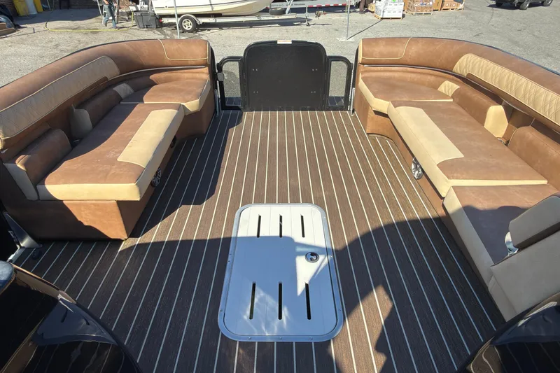 Slide: The Image of 2024 Premier Supersport boat interior with brown and beige seating, striped flooring. - 8