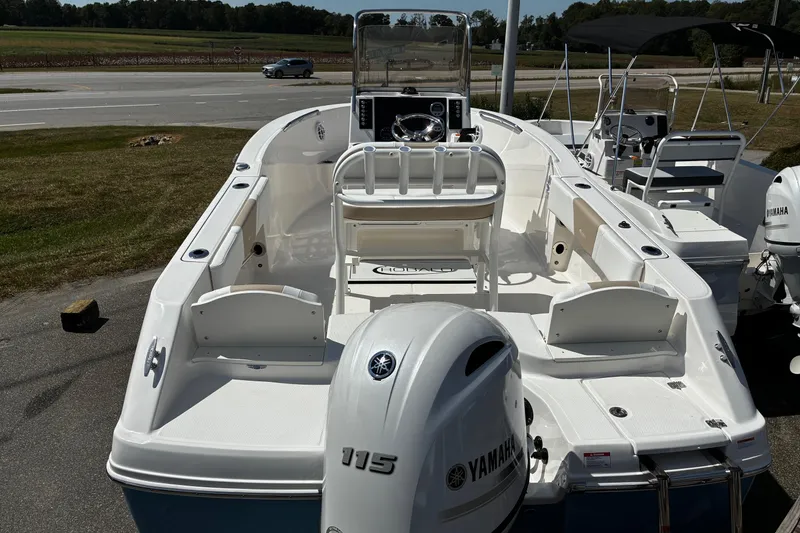 Slide: The Image of 2026 Robalo R180 Center Console boat with Yamaha 115 engine, parked outdoors. - 10