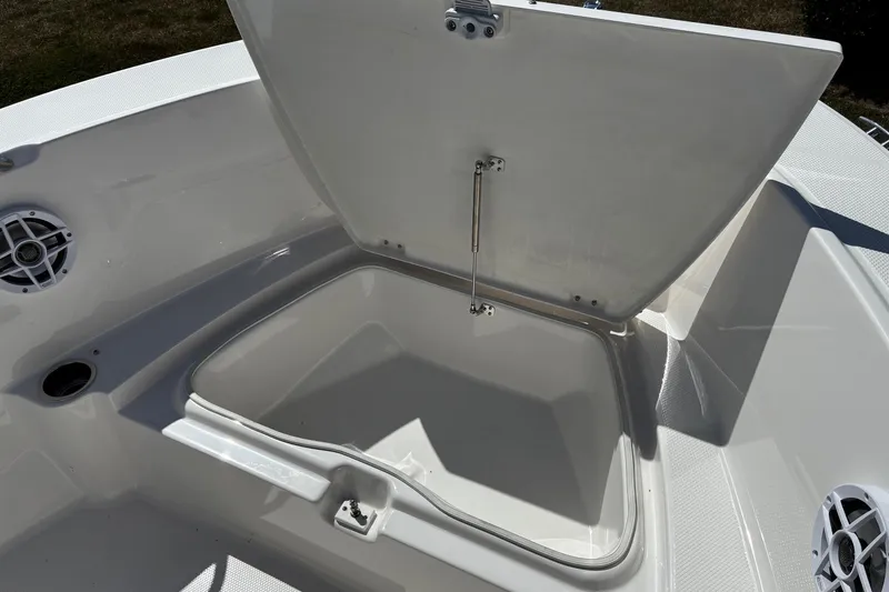 Slide: The Image of 2026 Robalo R180 Center Console boat storage compartment open, showcasing interior space. - 12