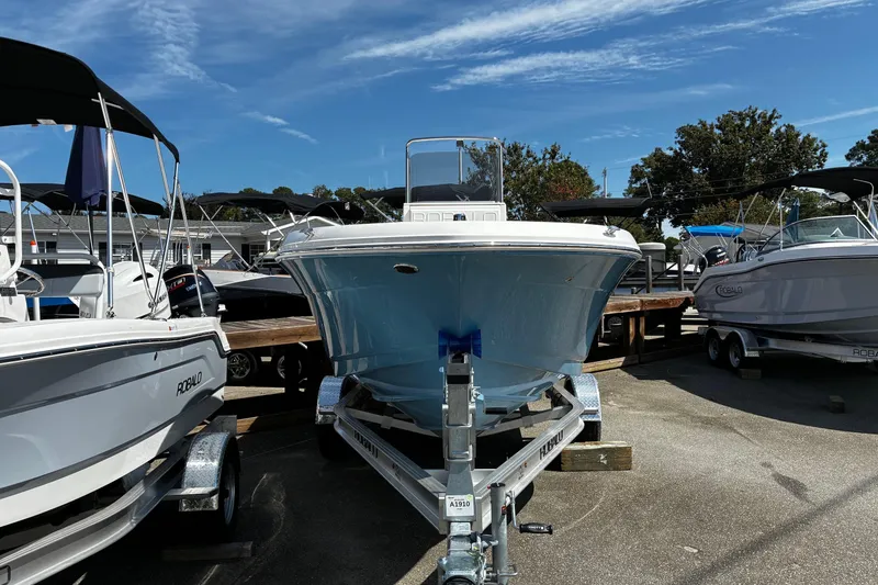 Slide: The Image of 2026 Robalo R180 Center Console boat on trailer, displayed outdoors under clear sky. - 3