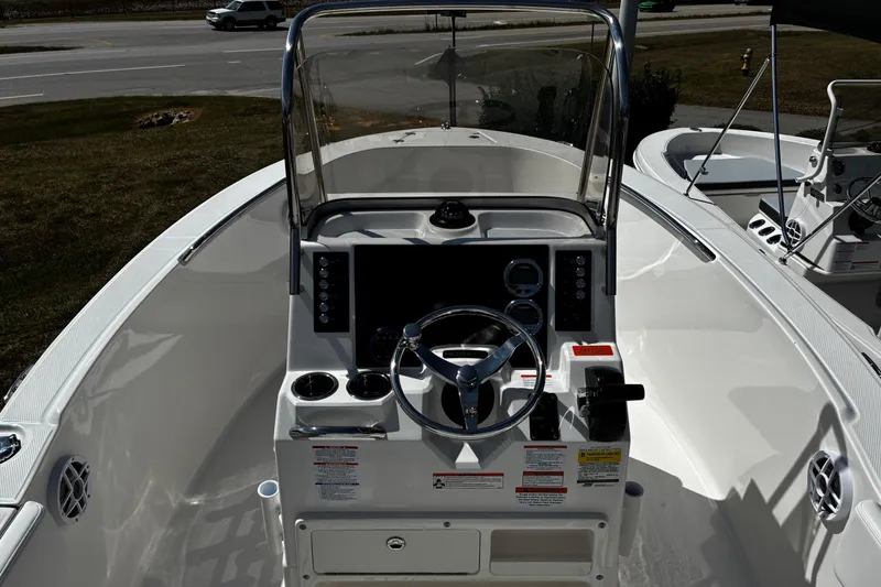 Slide: The Image of 2026 Robalo R180 Center Console boat interior with steering wheel and control panel. - 7