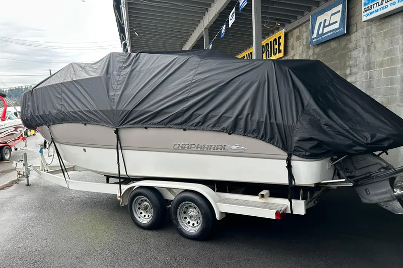 Slide: The Image of 2007 Chaparral Signature 240 boat covered on a trailer, parked outdoors. - 3