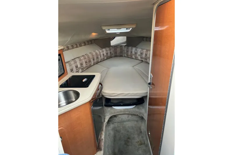 Slide: The Image of 2007 Chaparral Signature 240 cabin interior with kitchenette and sleeping area. - 7