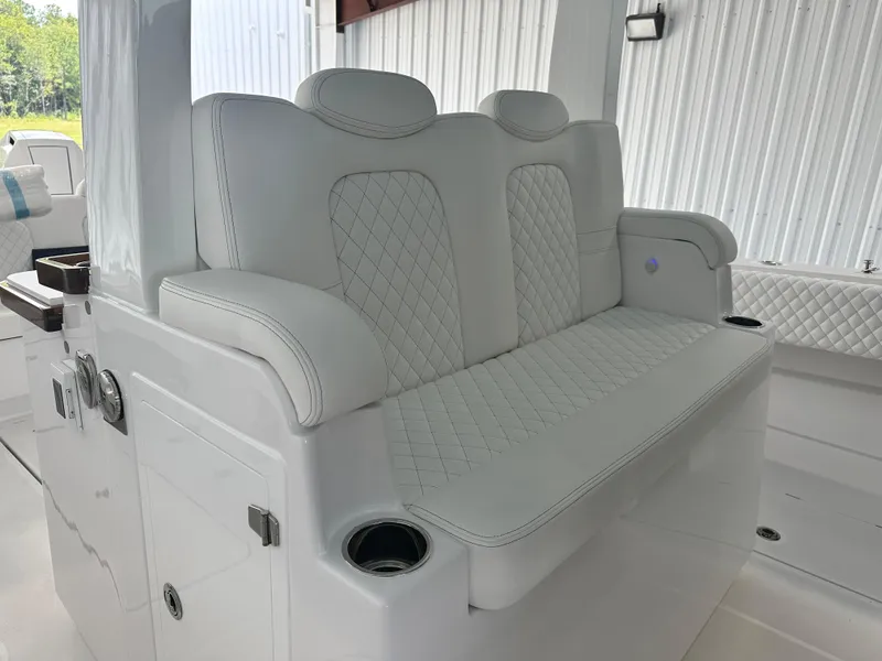 Slide: The Image of 2025 HCB Lujo boat interior with luxurious white seating and cup holders. - 12