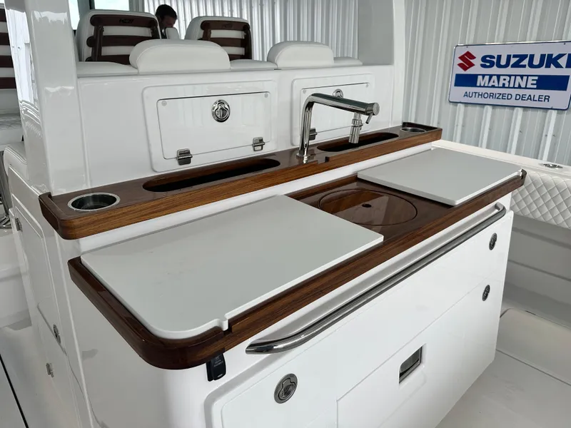 Slide: The Image of Luxury 2025 HCB Lujo boat interior with sleek kitchen area and Suzuki Marine signage. - 18